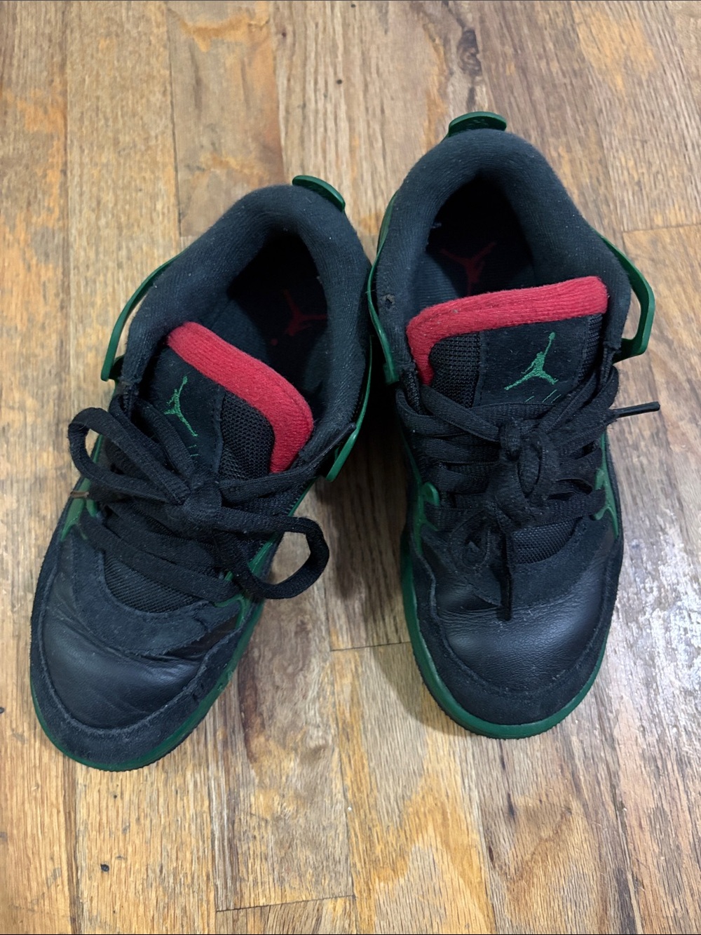 Nike Kids Black Sneakers with Green Trim and Red Tongue